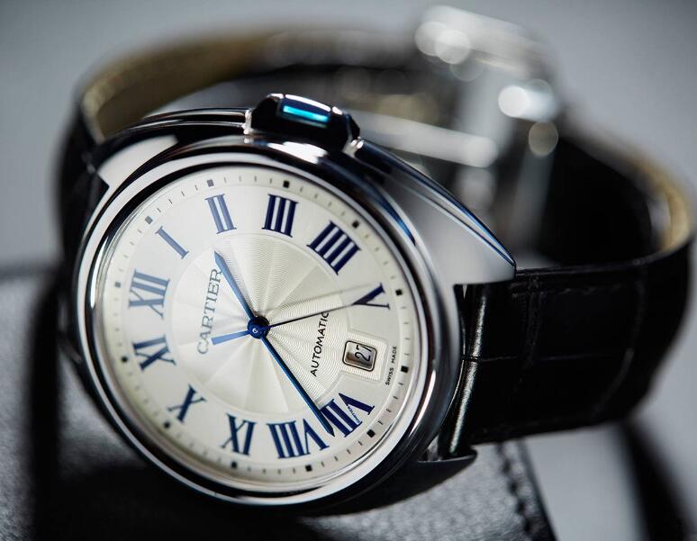 The blue hands and hour markers are striking on the silver dial.